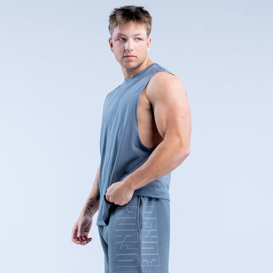Men's blue sleeveless graphic tank top, side view with geometric pattern at front