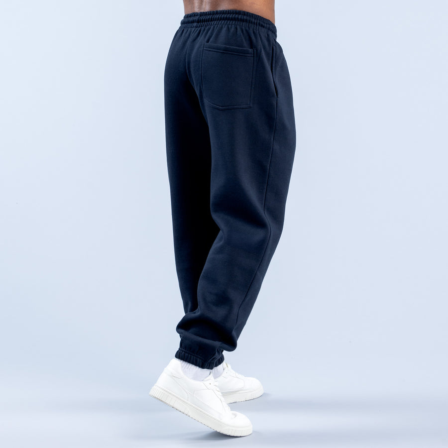 Navy jogger pants with elastic waistband, side pockets, and ribbed ankle cuffs