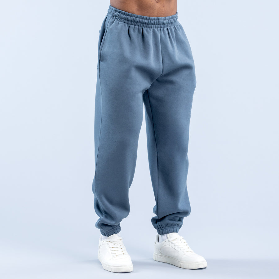Blue jogger pants with elastic waistband, tapered legs, side pockets, and ribbed cuffs