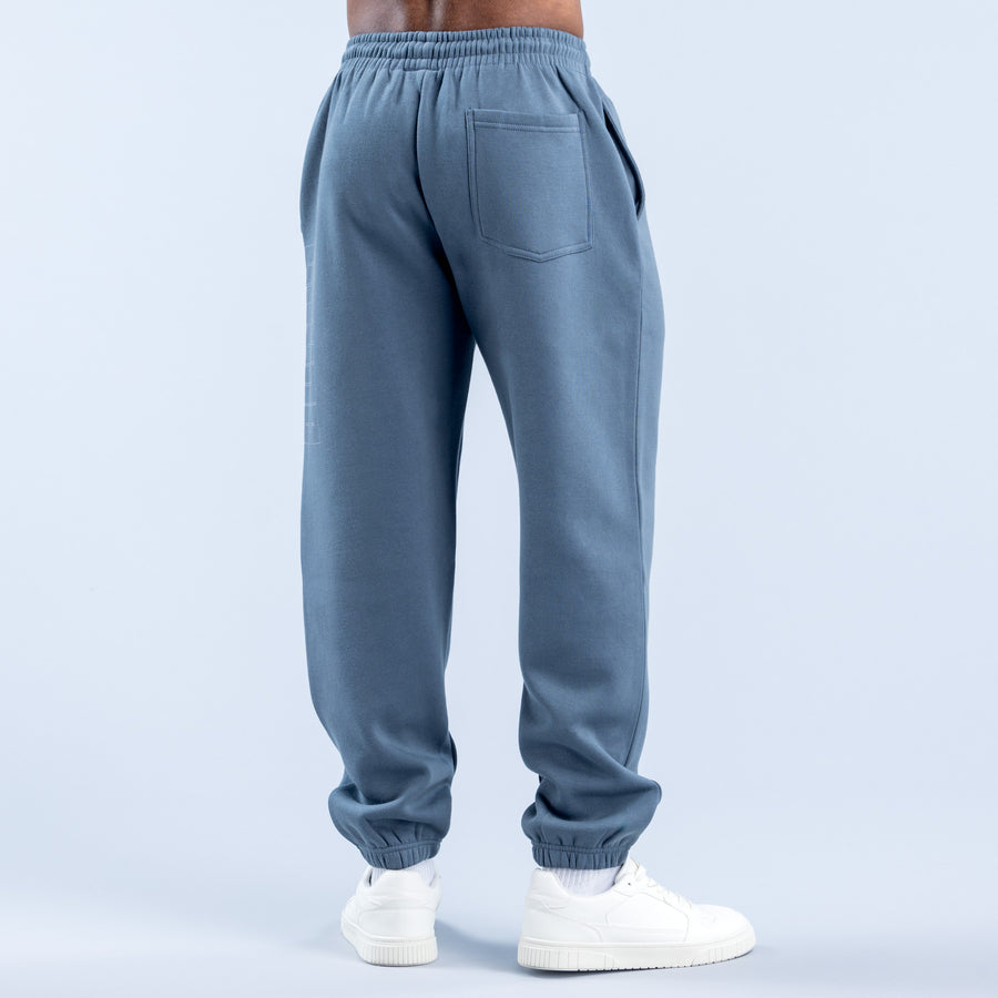 Blue jogger pants with elastic waistband, back patch pocket, and ribbed ankle cuffs