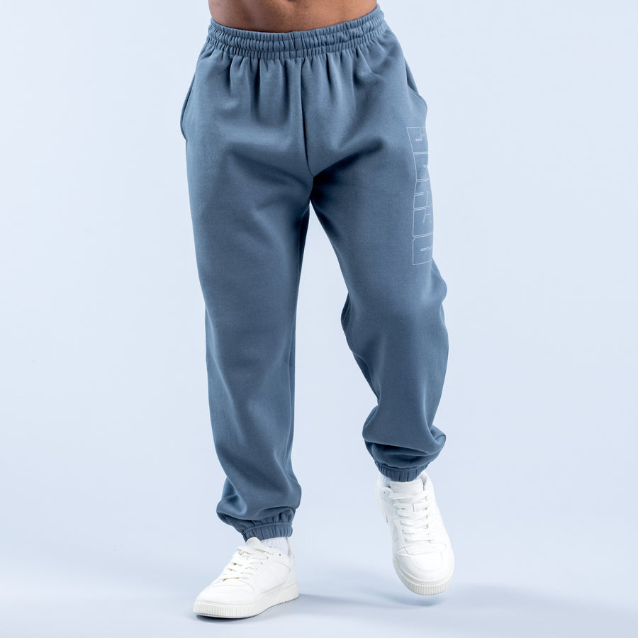 Blue jogger pants with elastic waistband and partial side graphic, ribbed ankle cuffs