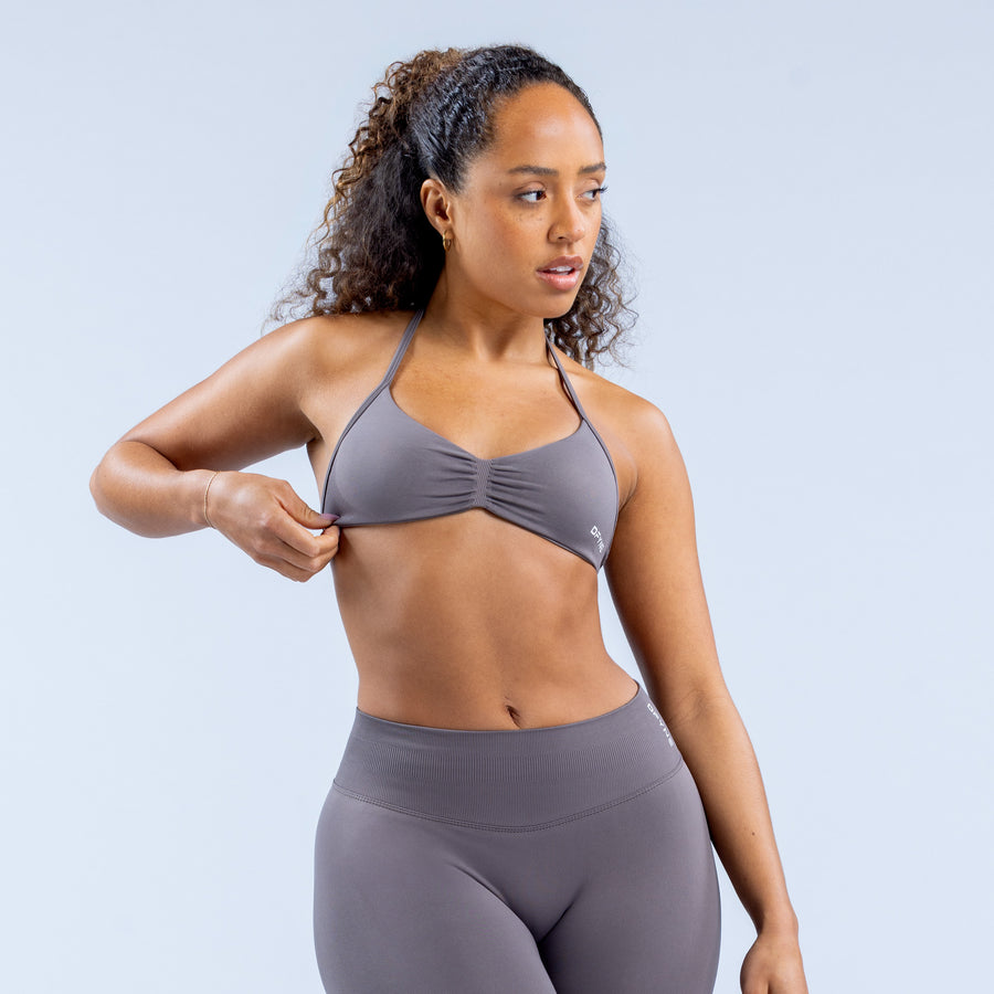 Gray strappy sports bra with twisted center knot and racerback straps