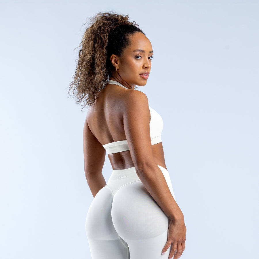 White sports bra with open back and racerback strap detail