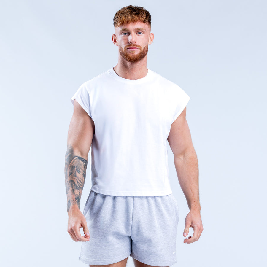White crop tank top with crew neck, sleeveless; cropped above the waist.