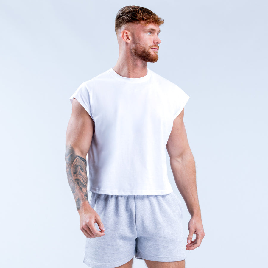 White crop tank top front view, sleeveless crew neck; cropped above the waist.