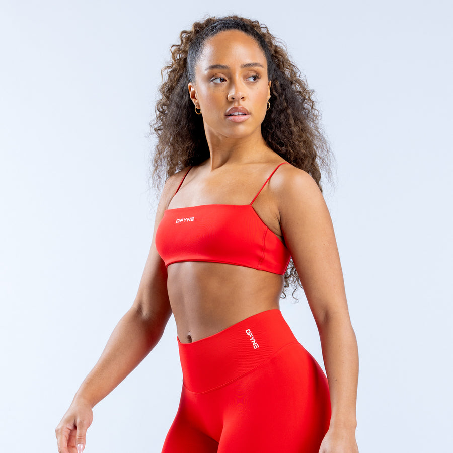Red strappy bra with scoop neckline and logo detail at center front