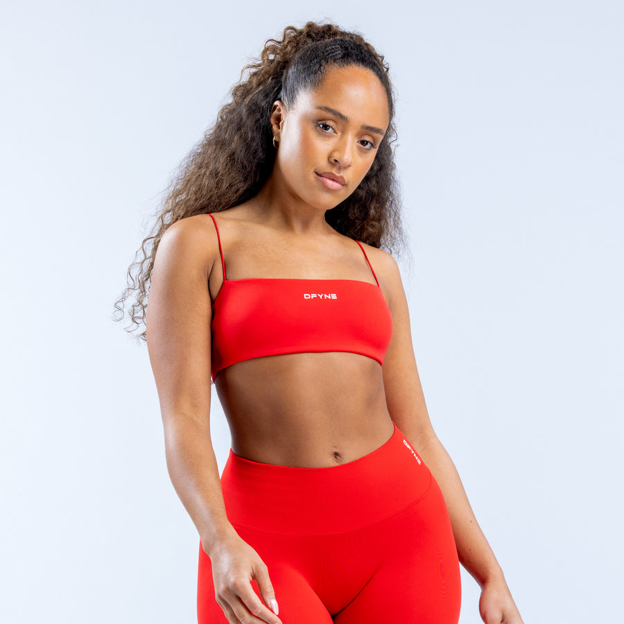 Red strappy sports bra with thin straps and smooth front panel