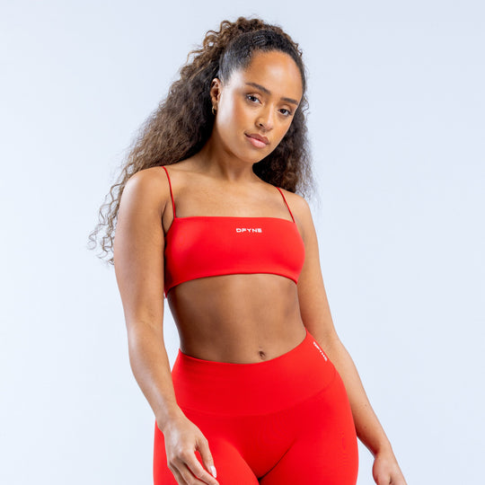 Red strappy sports bra with thin adjustable straps and front logo