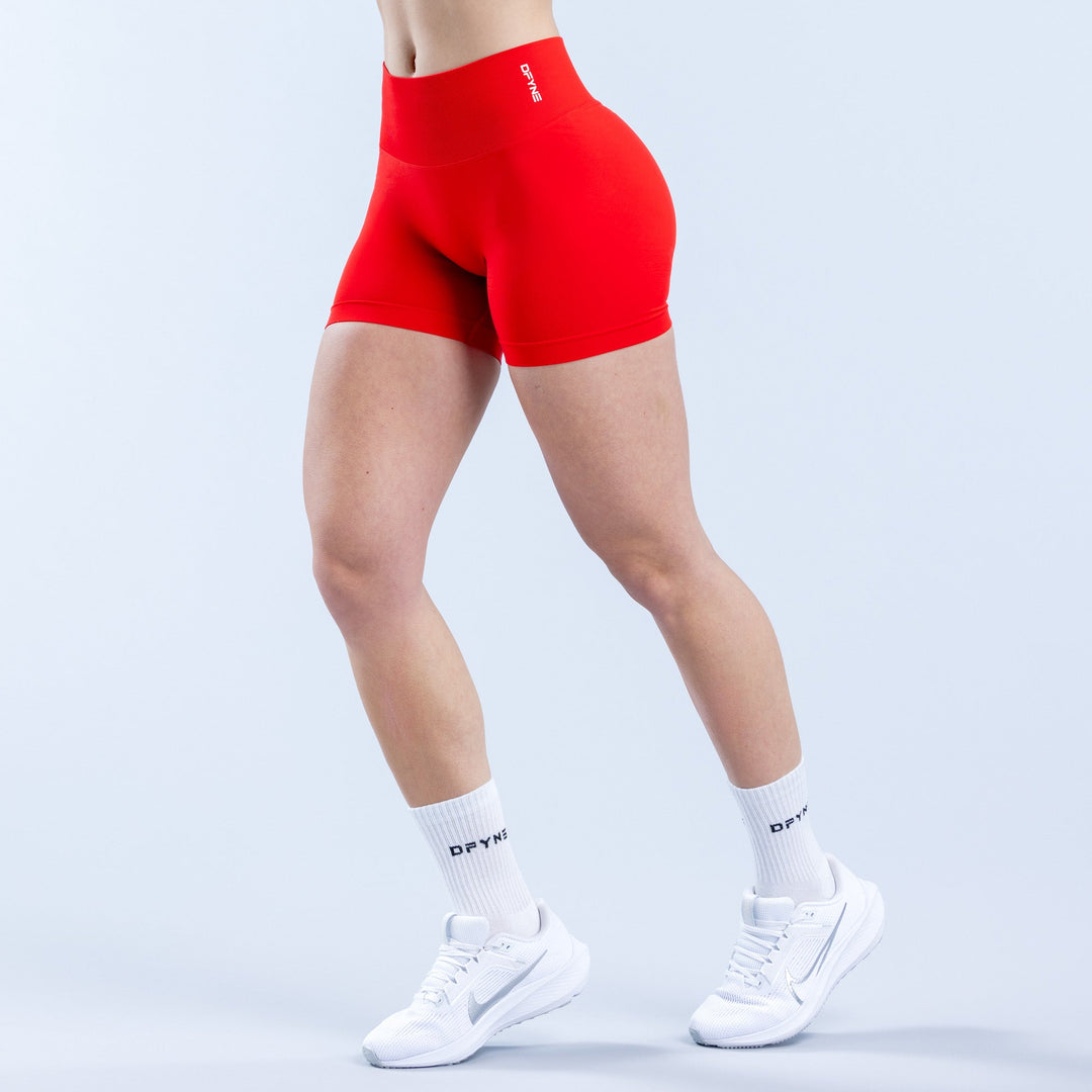 Red 4.5-inch performance shorts with snug fit and small waistband logo