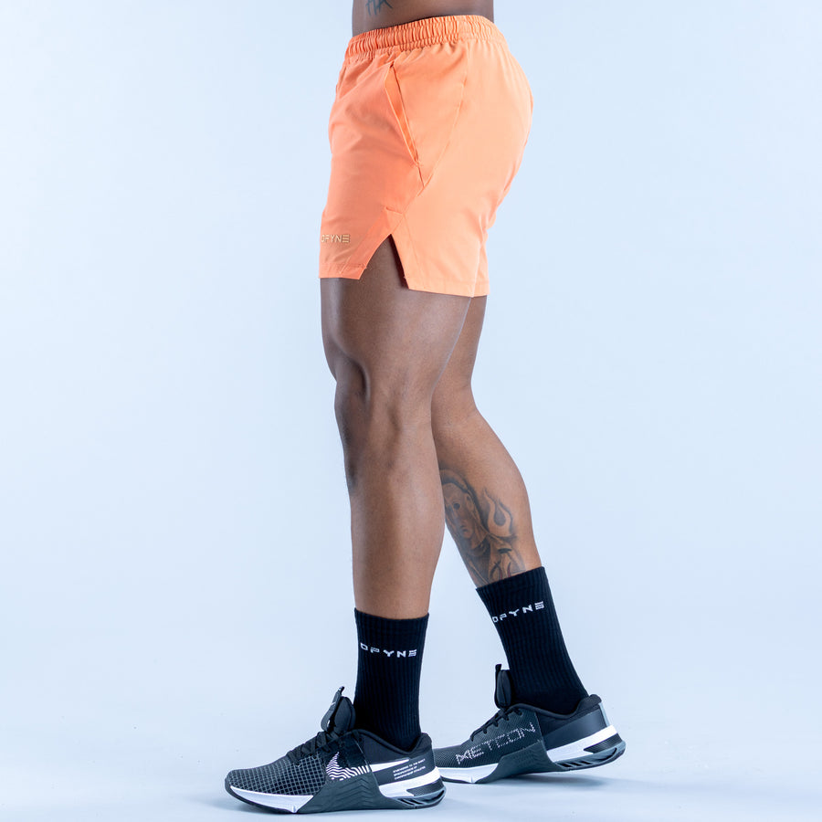 Peach orange training shorts shown from back with elastic waistband