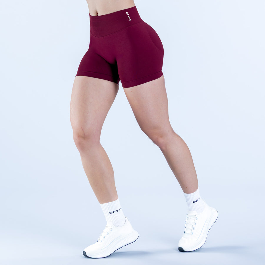 Burgundy 4.5-in impact shorts, back view on model with white socks