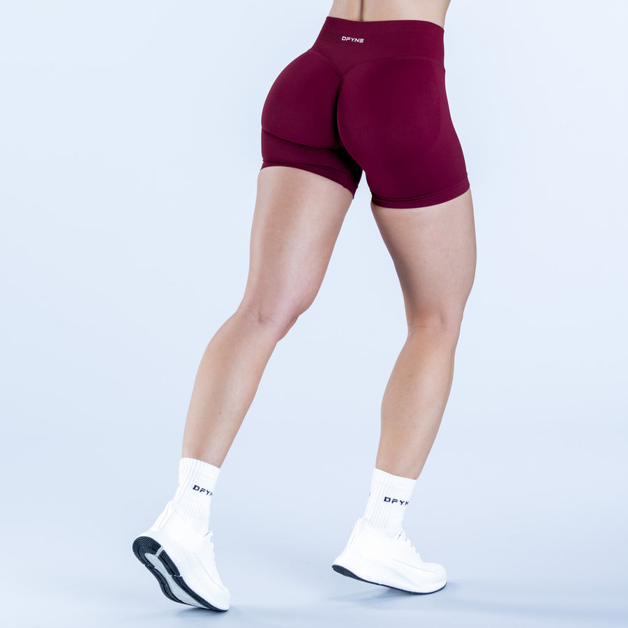Burgundy 4.5-in impact shorts with rear seam detail, angled back view