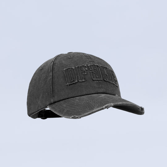 Distressed baseball cap with dark washed look, distressed seams, and front logo patch