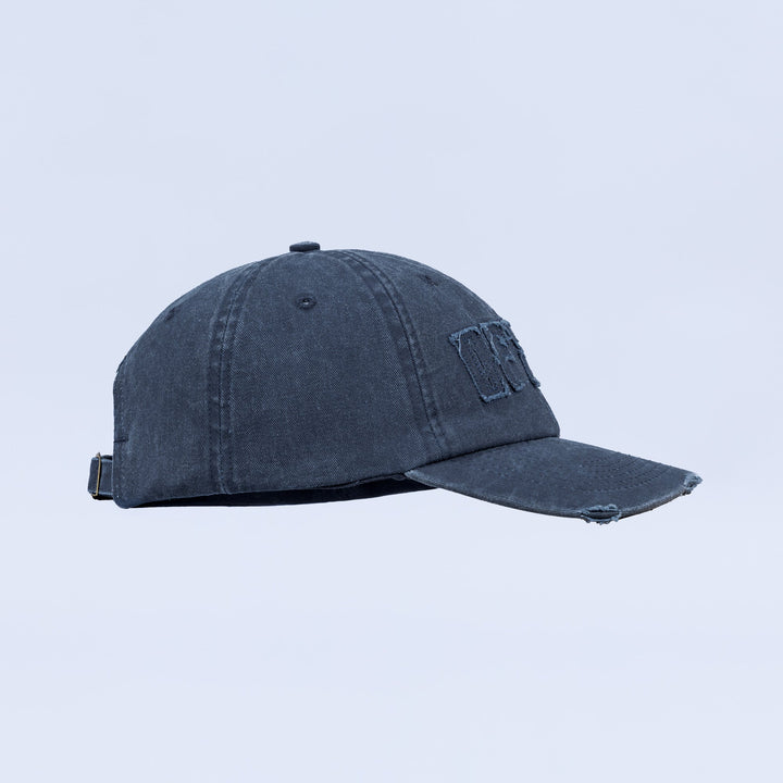 Distressed denim baseball cap with embroidered side logo and adjustable back strap