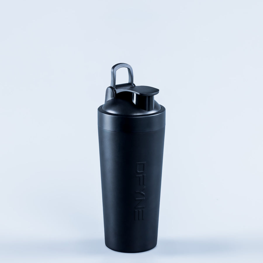 Shaker bottle with lid closed and carry loop, three-quarter view