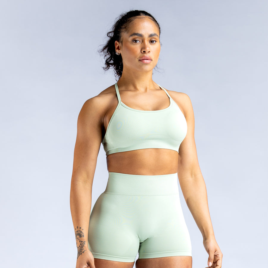 Mint sports bra with thin straps, scoop neckline, and racerback style