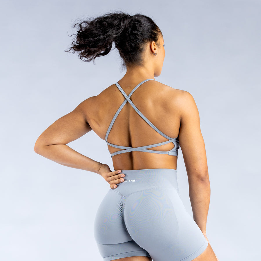 Light blue backless sports bra with crisscross open-back strap detail