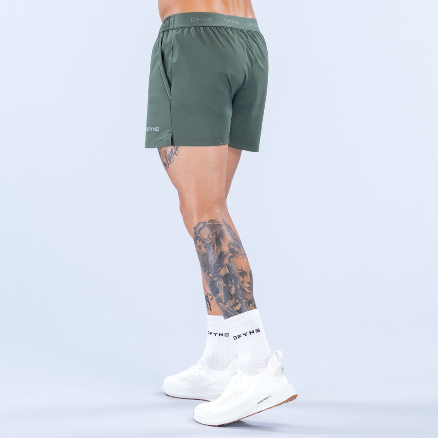 Dark green 4-inch training shorts, elastic waistband, thigh logo
