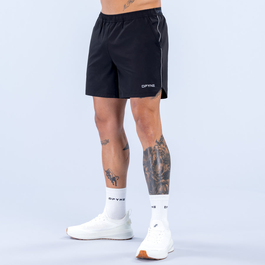 6" training shorts in dark black, rear view, elastic waistband and side stripe