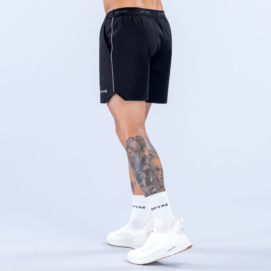 6" training shorts in dark black with elastic waistband and side stripe