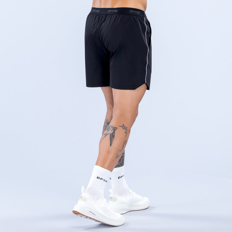 6" training shorts in dark black with elastic waistband and minimal logo detail