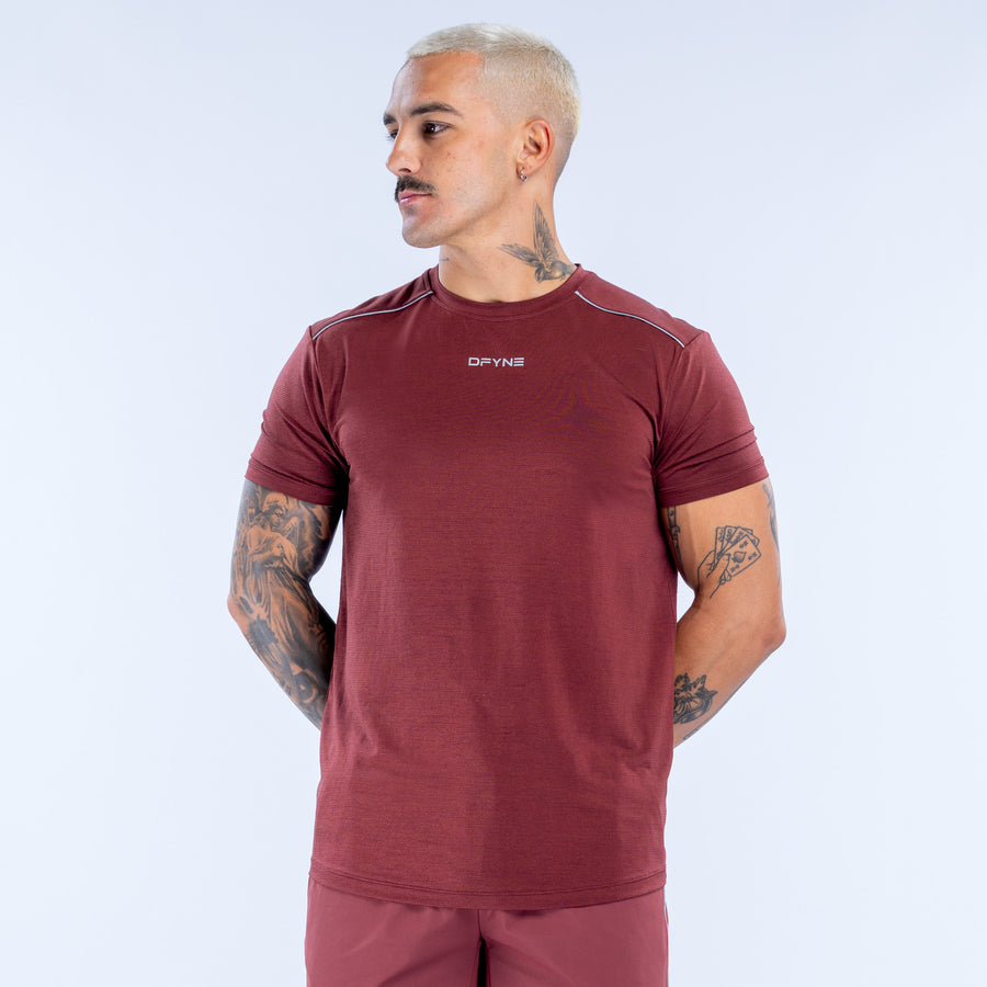 Burgundy athletic crewneck top with short sleeves and logo at chest