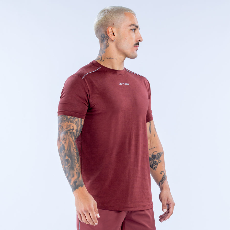 Burgundy athletic crewneck top with short sleeves and curved hem