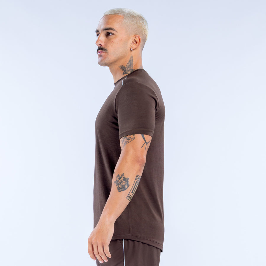 Dark brown active crewneck short-sleeve top, side view with chest logo