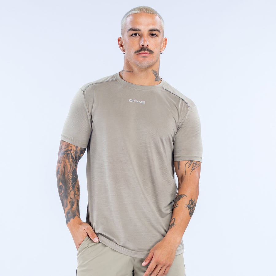 Light khaki active top with crew neck, short sleeves, small chest logo