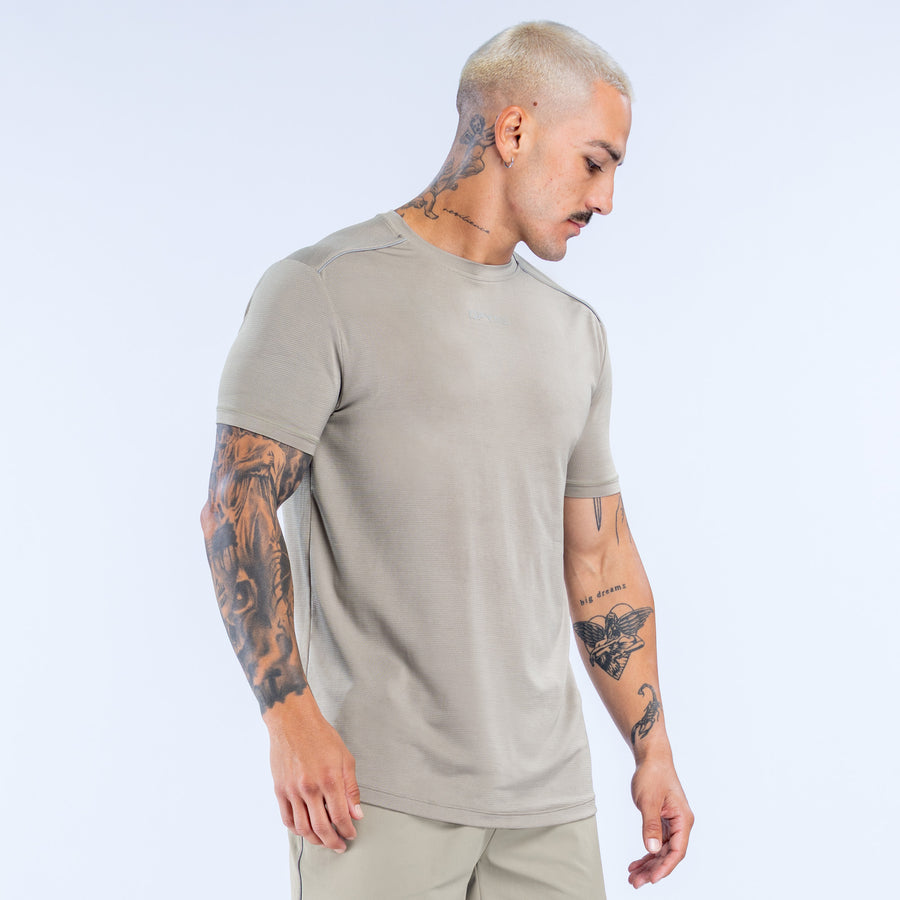 Light khaki active top with crew neck and short sleeves, side view