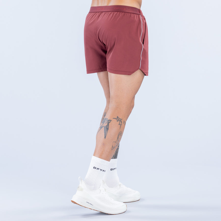Burgundy 4-inch training shorts with elastic waistband and drawcord, back view with printed logo