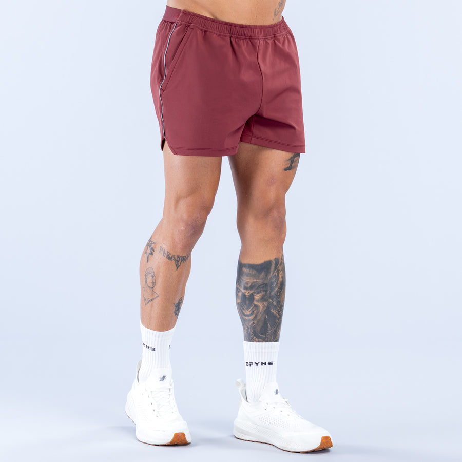 Burgundy 4-inch training shorts with elastic waistband and drawcord, logo on front
