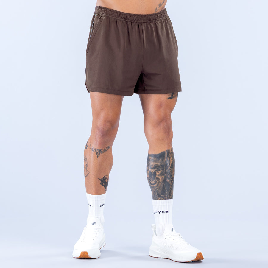 Brown training shorts with elastic waistband and small logo on front hem
