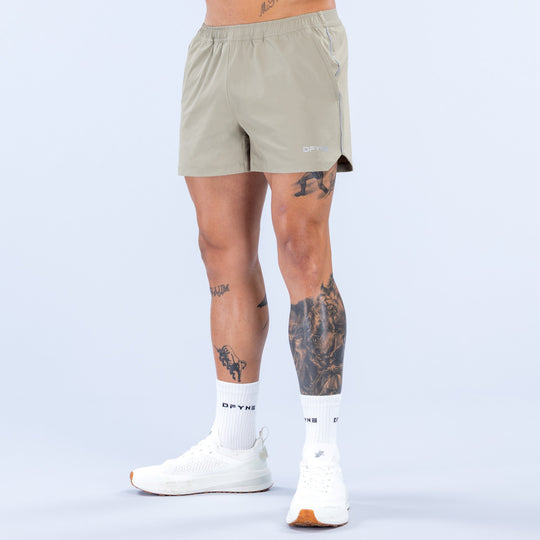 Olive 4-inch training shorts with elastic waistband and side logo