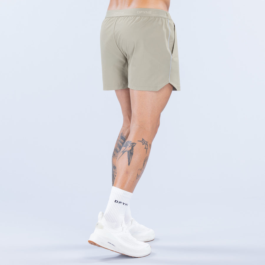 Light olive training shorts, 4-in inseam, elastic waistband, back view with straight hem.