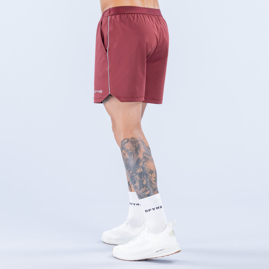 Burgundy training shorts back view with elastic waistband and logo, 6" inseam