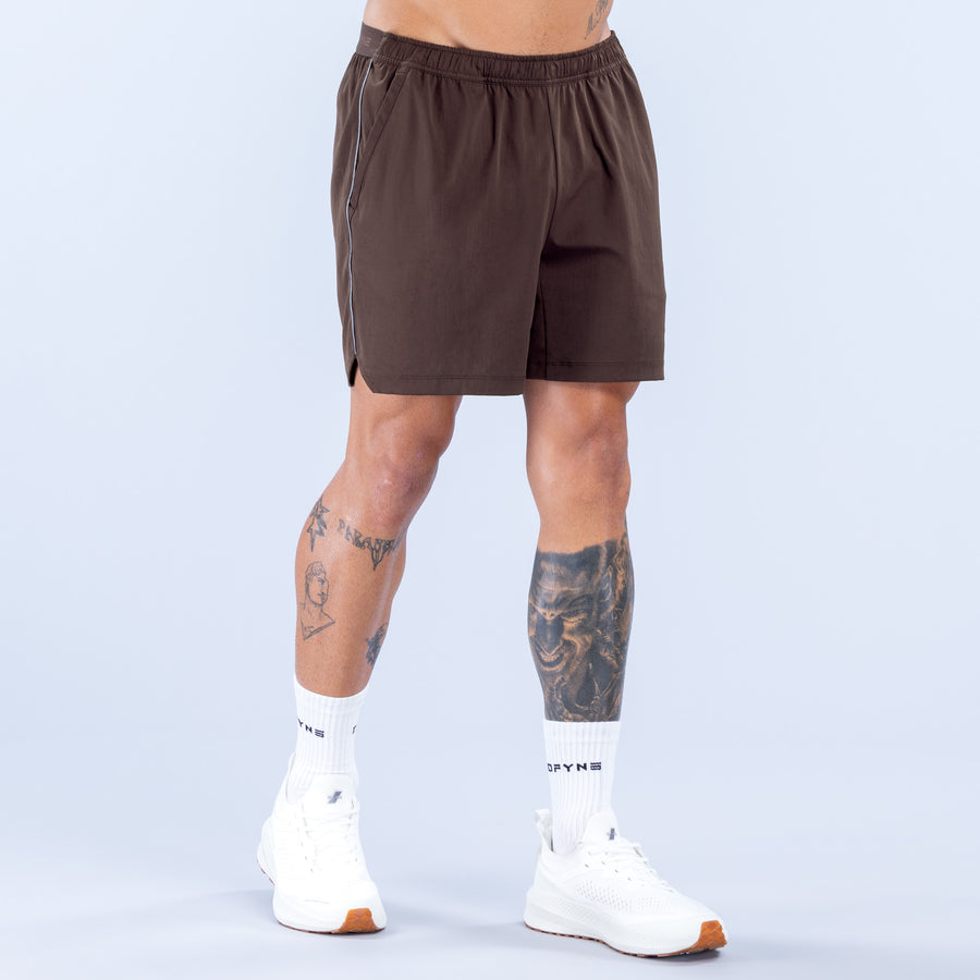 Brown training shorts front view, elastic waistband, DFYNS side logo, 6" inseam