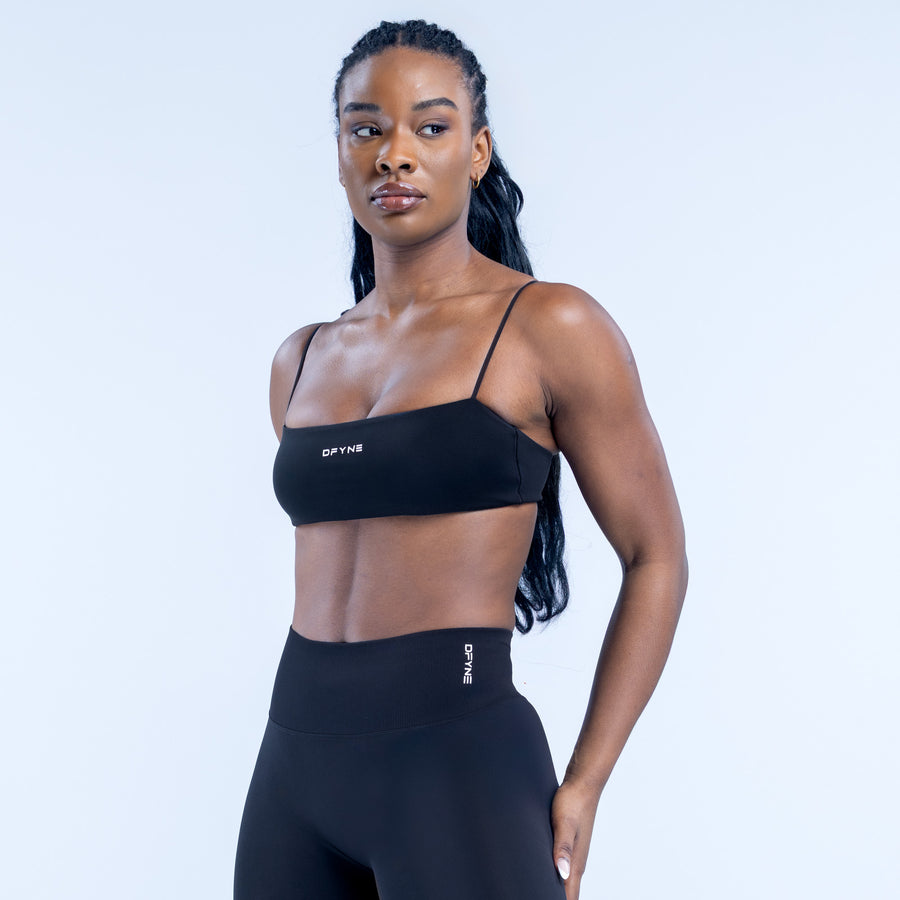 Black strappy bra with thin adjustable shoulder straps and elastic underband