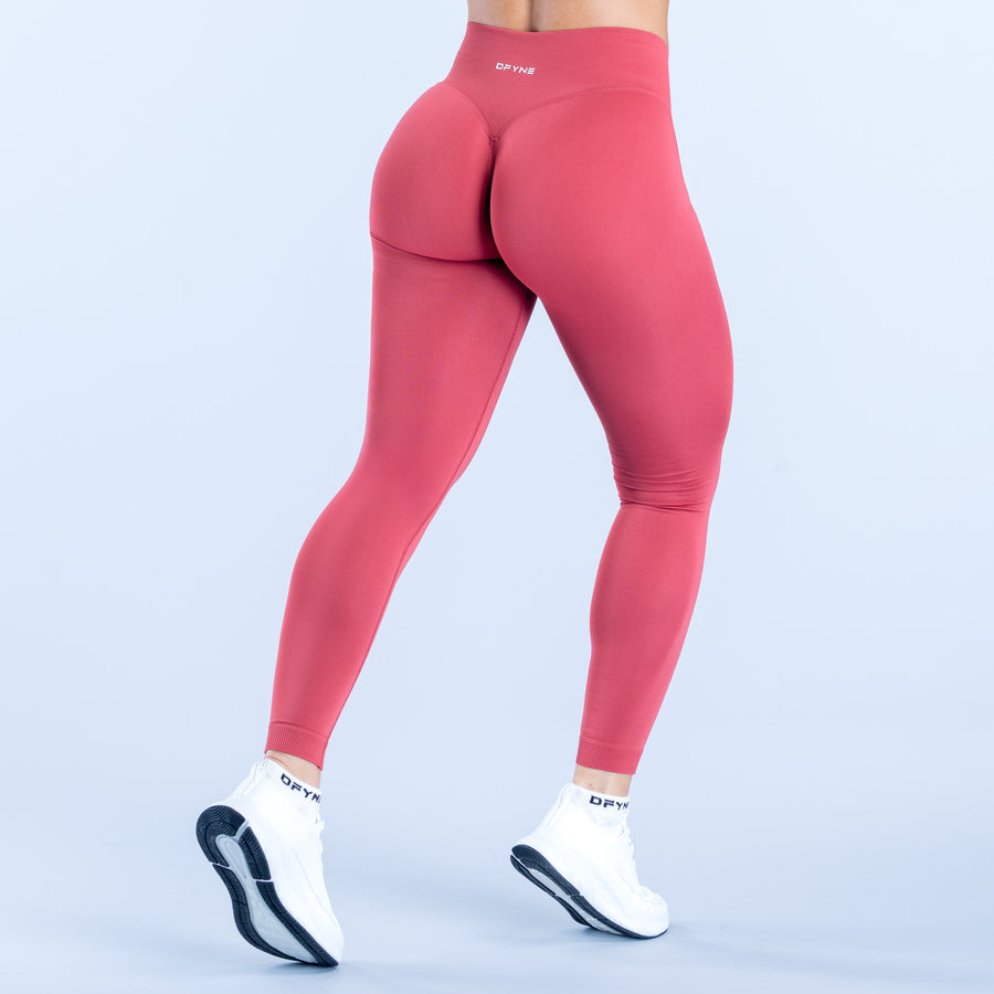 Back view of Defy leggings in pink with contoured hip seams