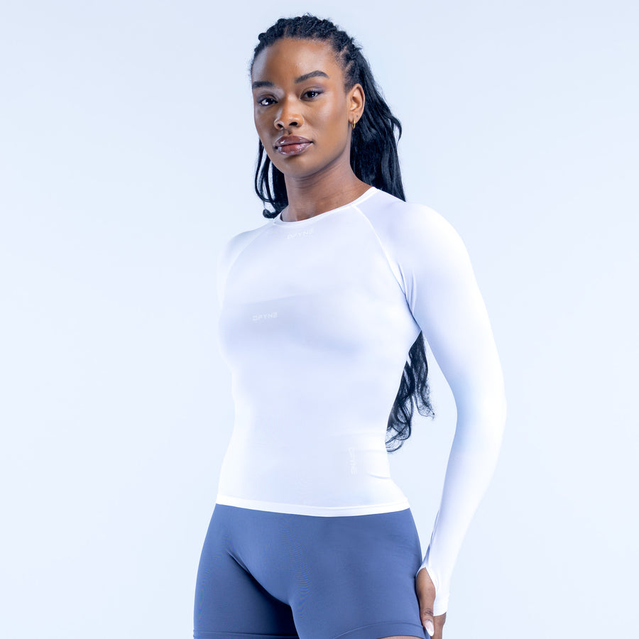White long sleeve athletic top with fitted waist and crew neck