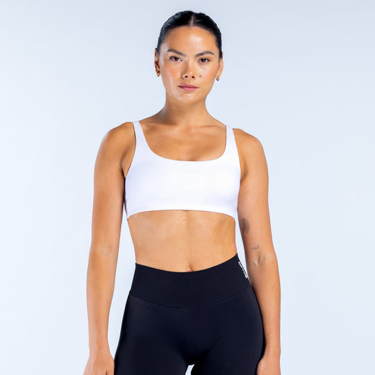 White scoop-back sports bra with wide straps and racerback cut