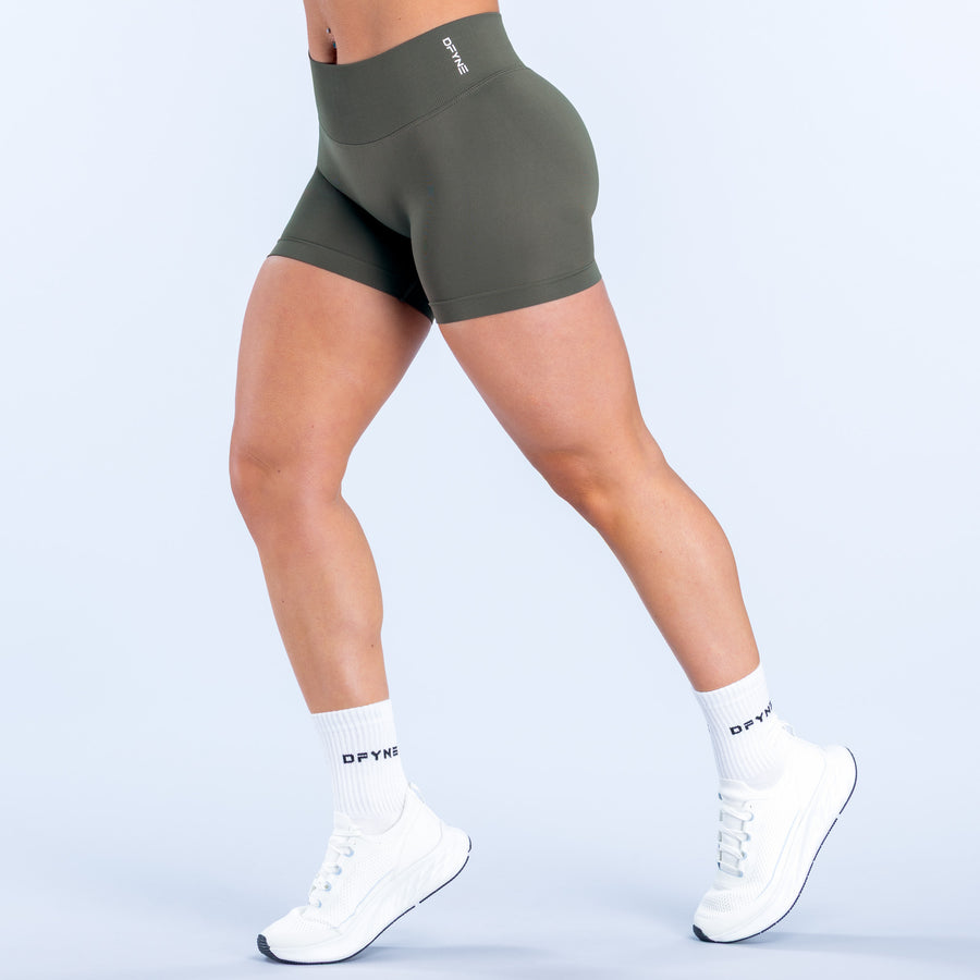 Defy 4.5-inch olive performance shorts, side view, mid-thigh length