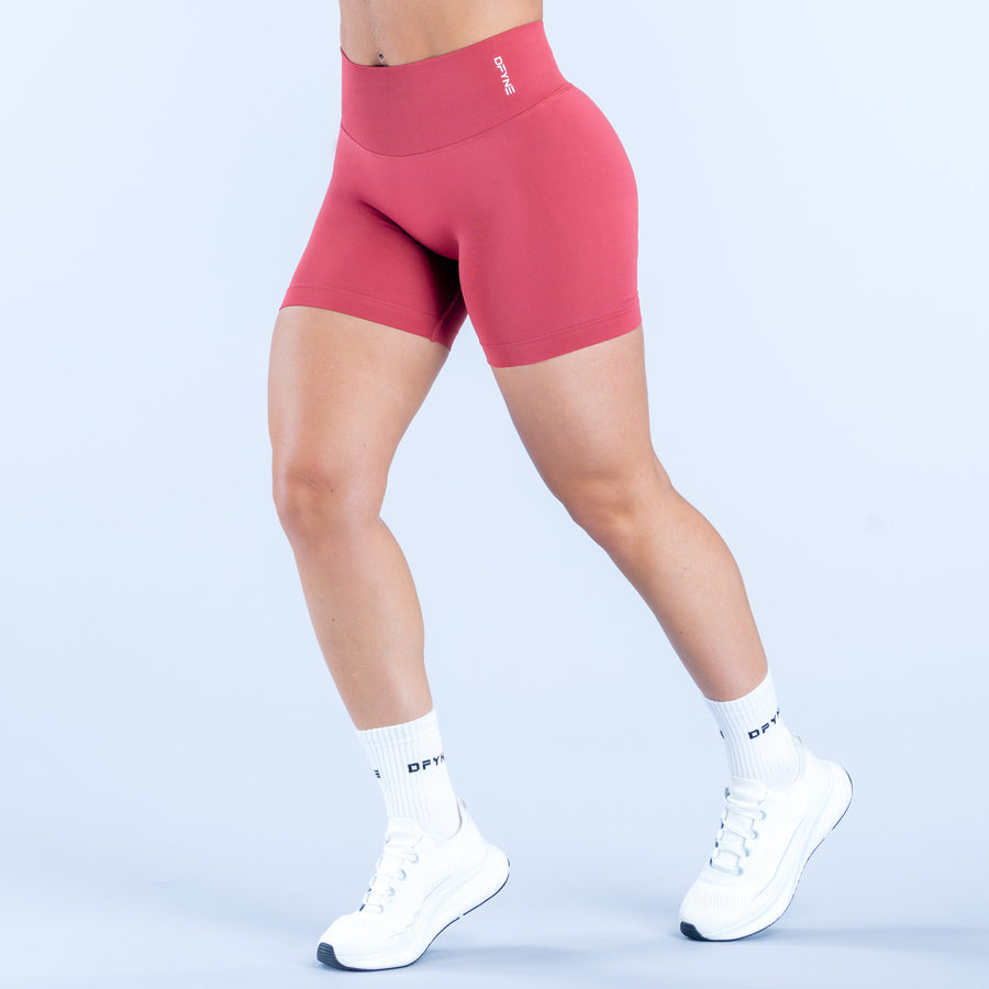 Defy 4.5-inch shorts in pink, mid-thigh length with smooth waistband