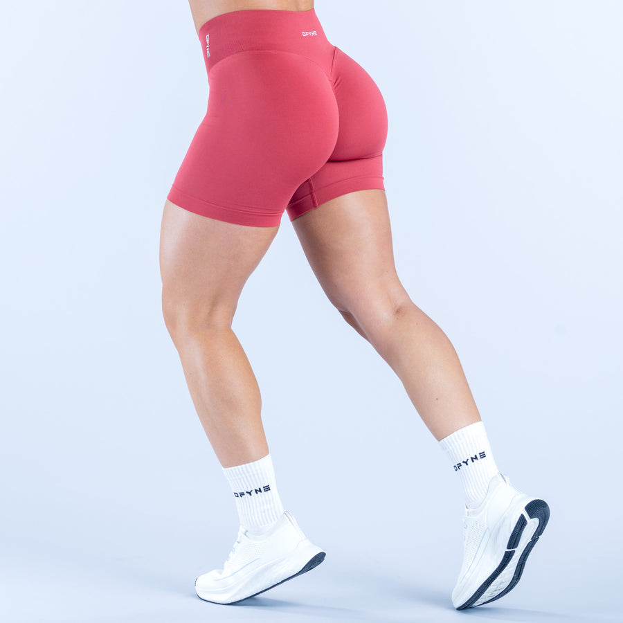 4.5-inch pink shorts, form-fitting mid-thigh cut with smooth waistband
