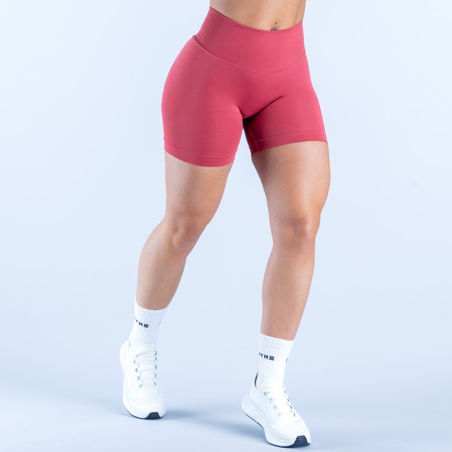 4.5-inch pink shorts, snug fit with smooth waistband and mid-thigh length