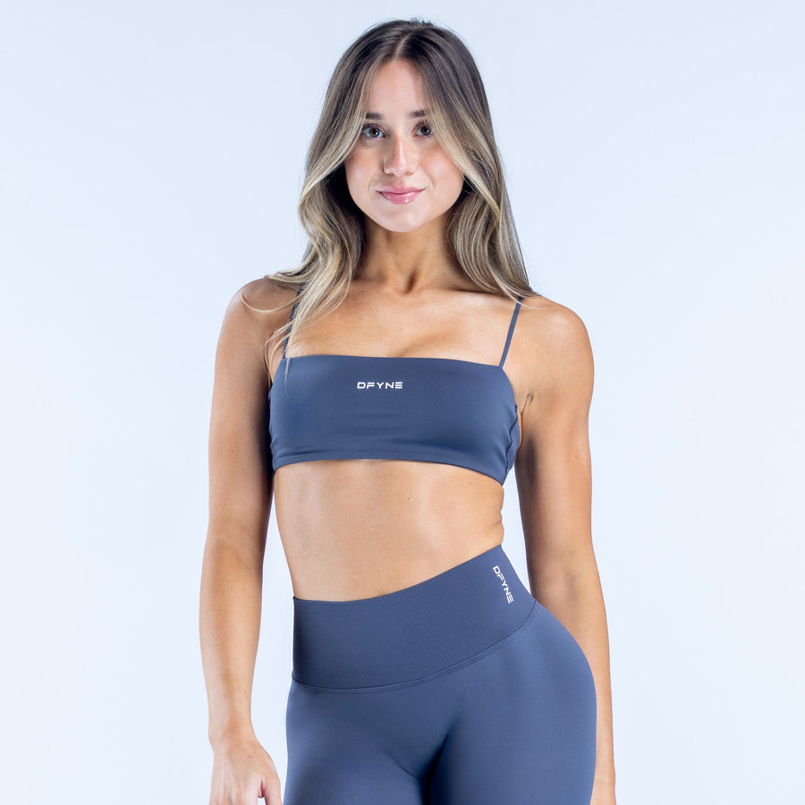 Navy strappy sports bra, front view, thin straps and DYNE logo