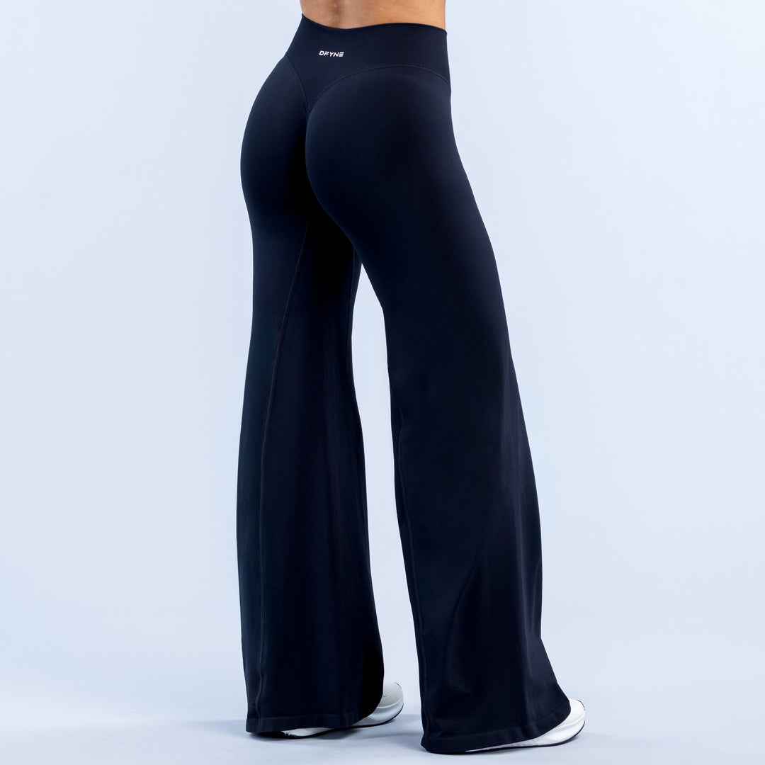 Dark navy high-rise flared leggings with wide bell legs and small logo on waistband