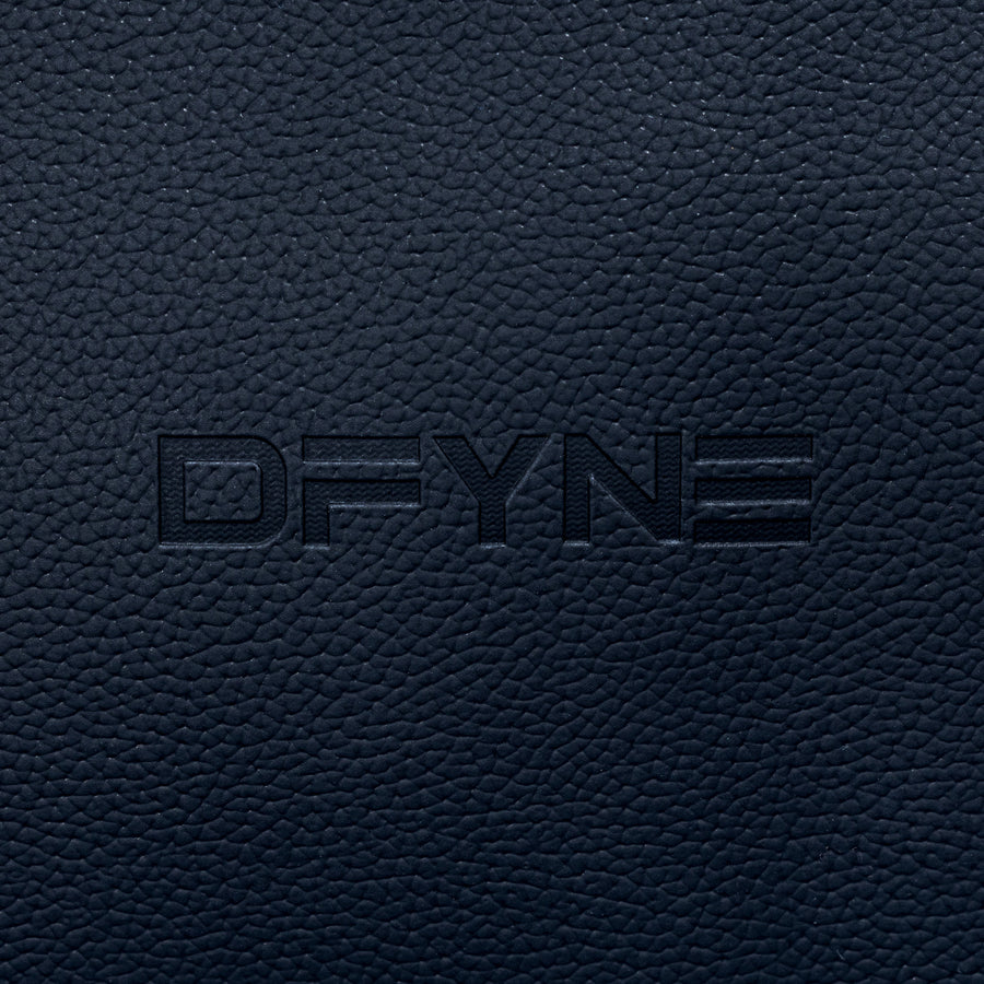 Duffle bag embossed logo on textured dark blue fabric panel.