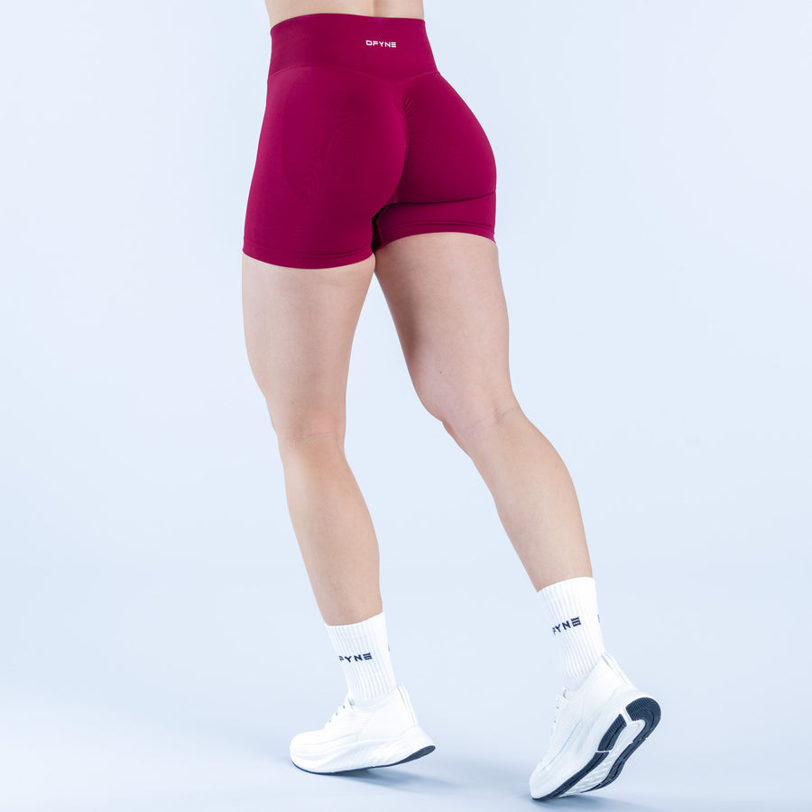 Burgundy 4.5 in athletic shorts, fitted back view with waistband logo