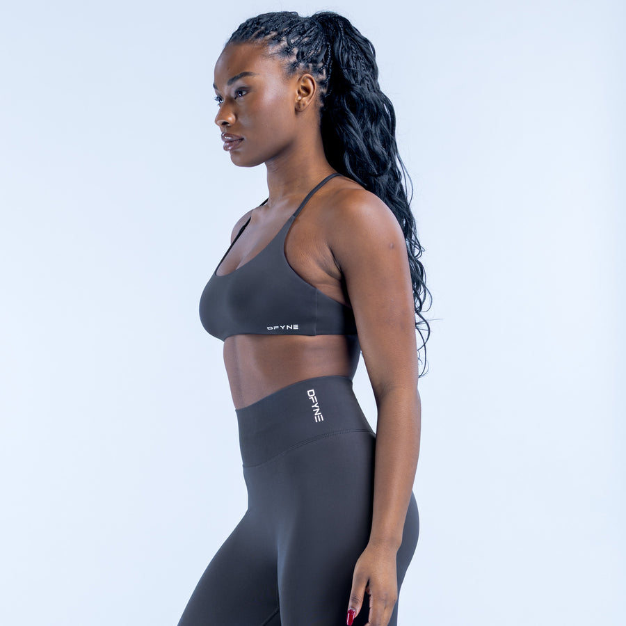 Sports bra in dark gray, side view with thin shoulder straps